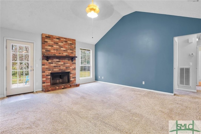 unfurnished living room featuring light colored carpet, vaulted ceiling, and a wealth of natural light