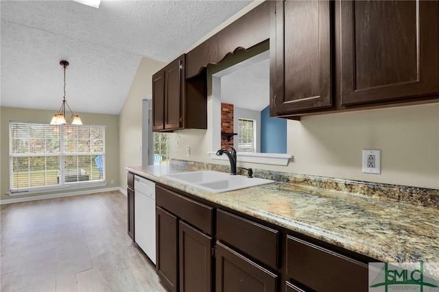 kitchen featuring dishwasher, a healthy amount of sunlight, vaulted ceiling, and sink