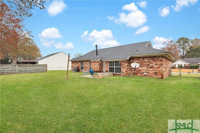 rear view of house featuring cooling unit, a yard, and a patio