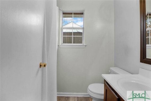 bathroom featuring hardwood / wood-style floors, vanity, and toilet