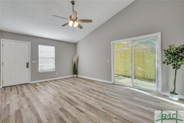 unfurnished living room with a textured ceiling, light hardwood / wood-style floors, high vaulted ceiling, and ceiling fan