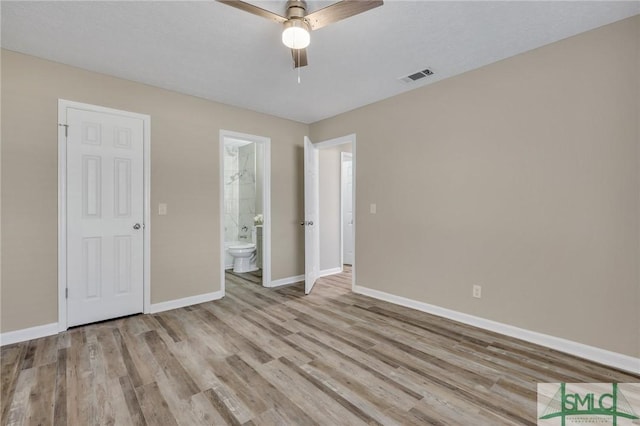 unfurnished bedroom with light hardwood / wood-style floors, ceiling fan, and ensuite bathroom