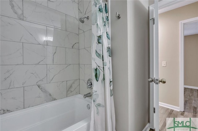 bathroom featuring hardwood / wood-style floors and shower / tub combo with curtain