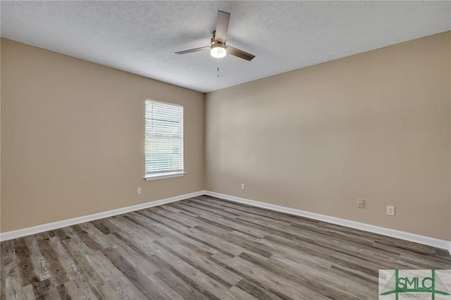 unfurnished room with ceiling fan, light wood-type flooring, and a textured ceiling