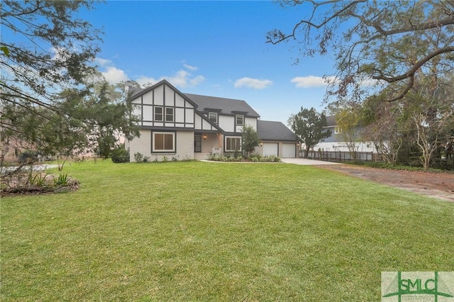 rear view of house with a lawn and a garage