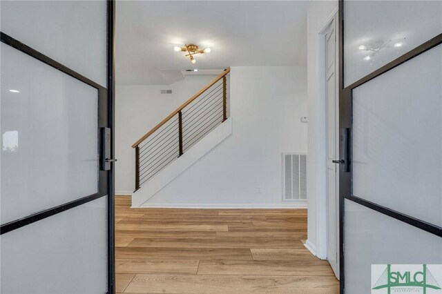 stairway featuring hardwood / wood-style flooring