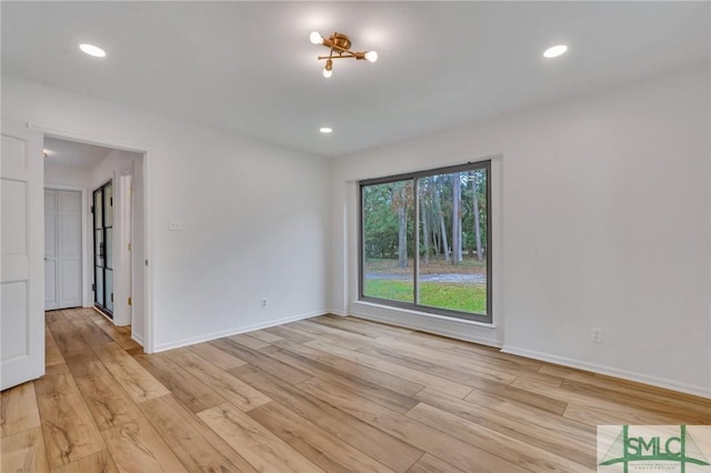 unfurnished room with light hardwood / wood-style floors