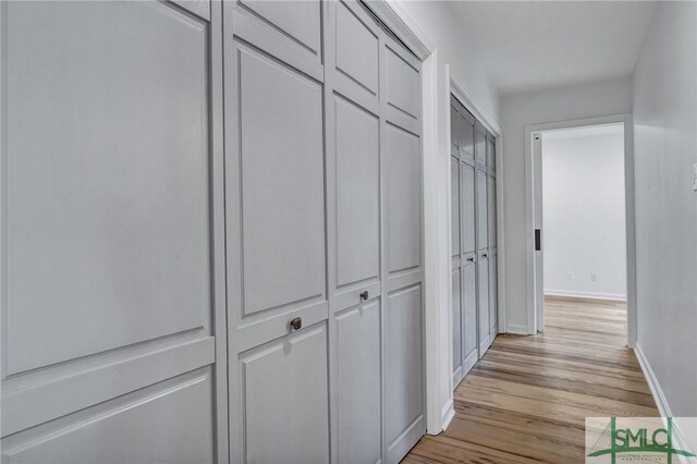 hallway with light wood-type flooring