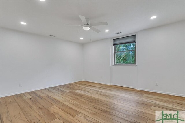 empty room with light wood-type flooring and ceiling fan