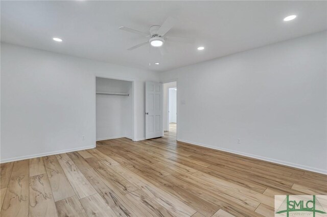 unfurnished bedroom with ceiling fan, a closet, and light hardwood / wood-style flooring