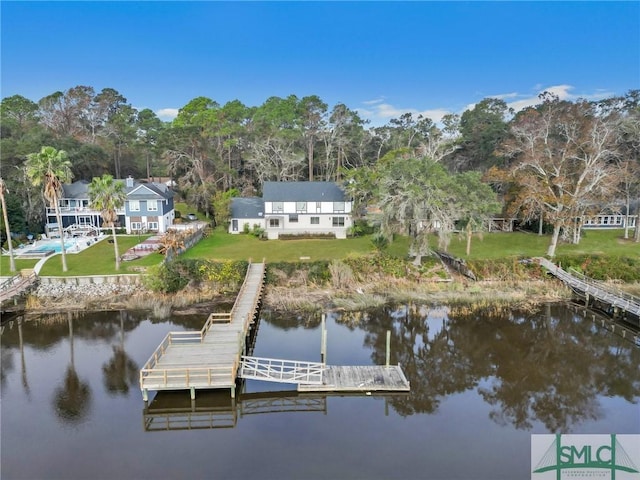 dock area with a yard and a water view