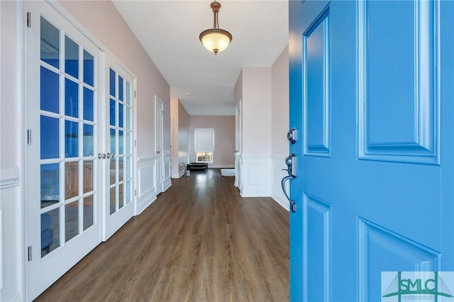 foyer featuring dark hardwood / wood-style floors and french doors