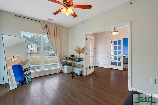 interior space featuring french doors, ceiling fan, and dark wood-type flooring