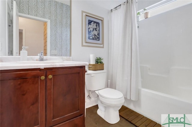 full bathroom with tile patterned flooring, shower / bath combo with shower curtain, vanity, and toilet