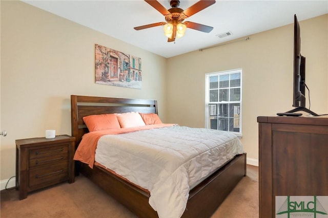 bedroom with ceiling fan and light carpet