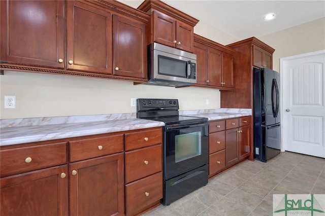 kitchen featuring light tile patterned flooring and black appliances