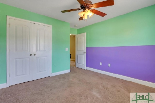 unfurnished bedroom with light colored carpet, a closet, and ceiling fan