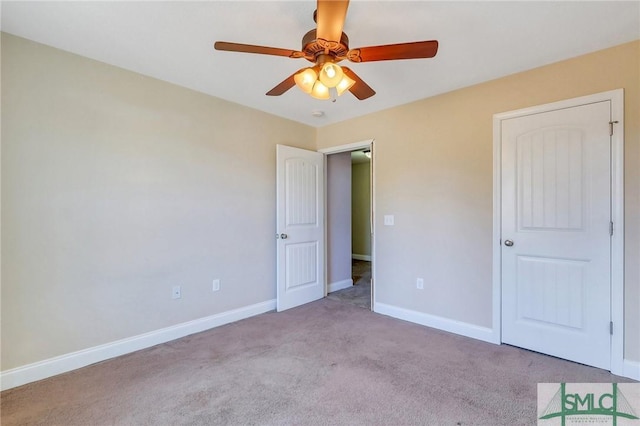 unfurnished bedroom with light colored carpet and ceiling fan