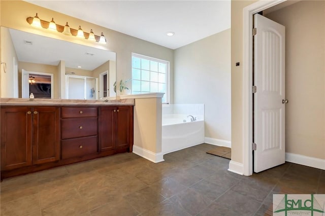 bathroom with vanity and shower with separate bathtub