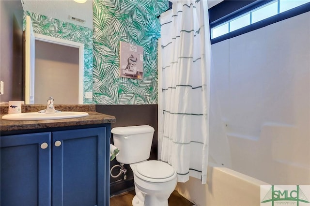 full bathroom featuring vanity, toilet, and shower / tub combo with curtain