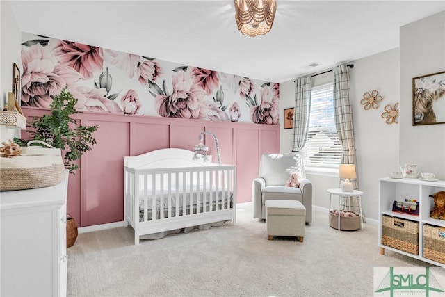 carpeted bedroom featuring a crib