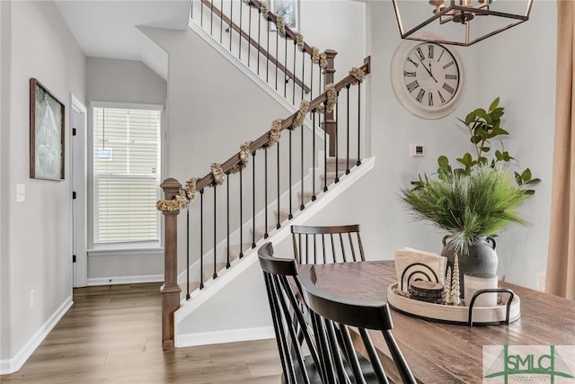 dining area featuring a chandelier, plenty of natural light, and hardwood / wood-style floors