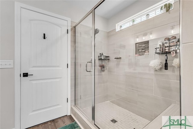 bathroom featuring hardwood / wood-style floors and a shower with shower door