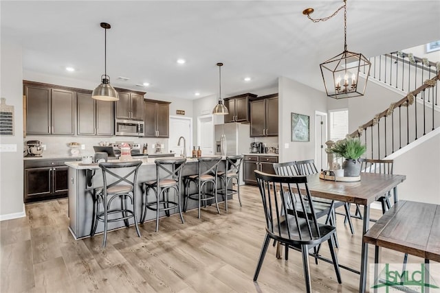 dining room with a chandelier and light hardwood / wood-style floors