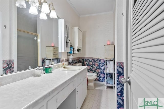 bathroom with vanity, tile patterned flooring, toilet, ornamental molding, and an enclosed shower