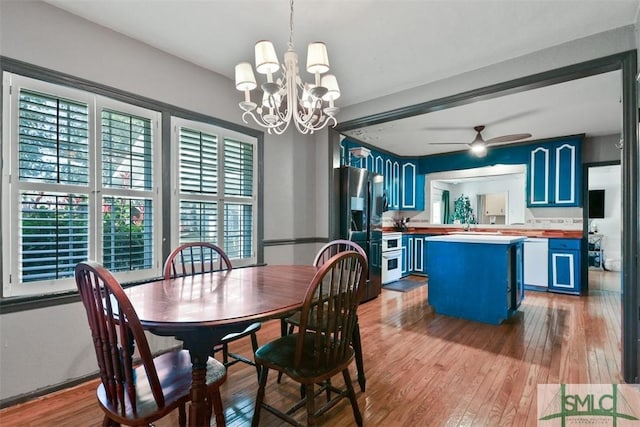 dining area with ceiling fan with notable chandelier and light wood-type flooring