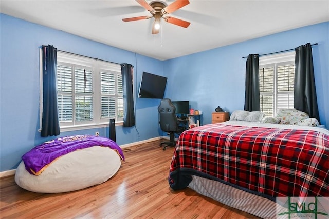 bedroom with ceiling fan and wood-type flooring