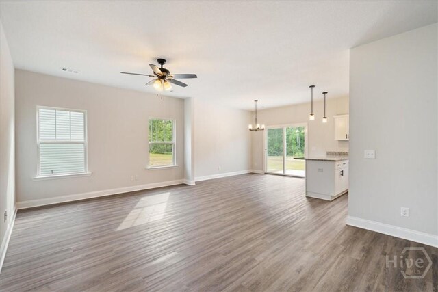 287 Timberlake Dr, Guyton, GA 31312 - unfurnished living room with a chandelier, ceiling fan, wood finished floors, and baseboards