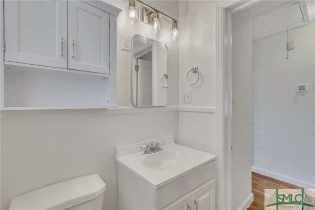 bathroom featuring hardwood / wood-style floors, vanity, and toilet