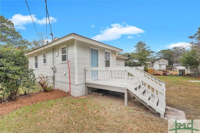 exterior space featuring a lawn and a deck