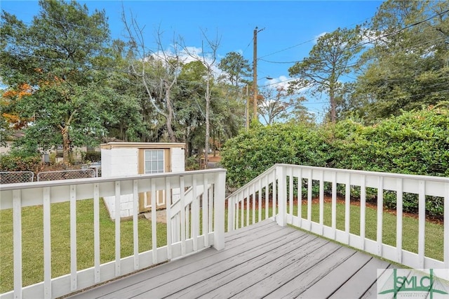 wooden terrace with a lawn