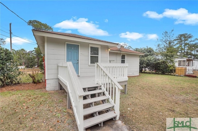 exterior space featuring a lawn and a wooden deck