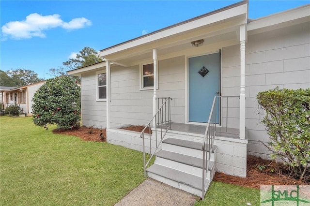 property entrance with a lawn