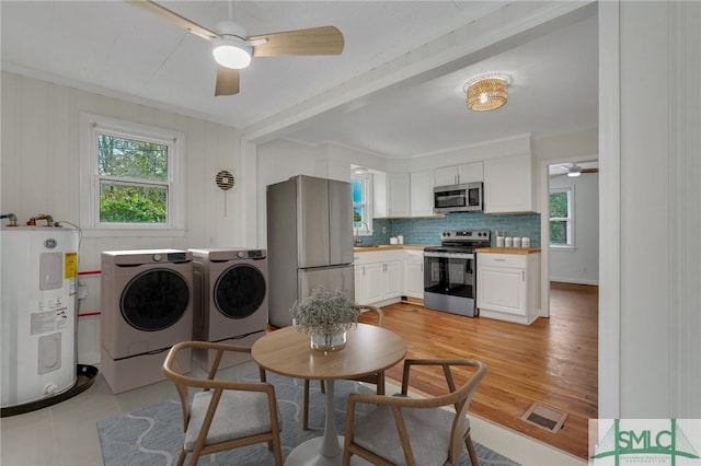 interior space featuring water heater, crown molding, ceiling fan, and washer and dryer