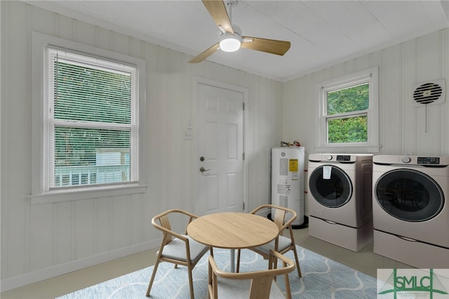 laundry area with ceiling fan, washing machine and clothes dryer, ornamental molding, and water heater