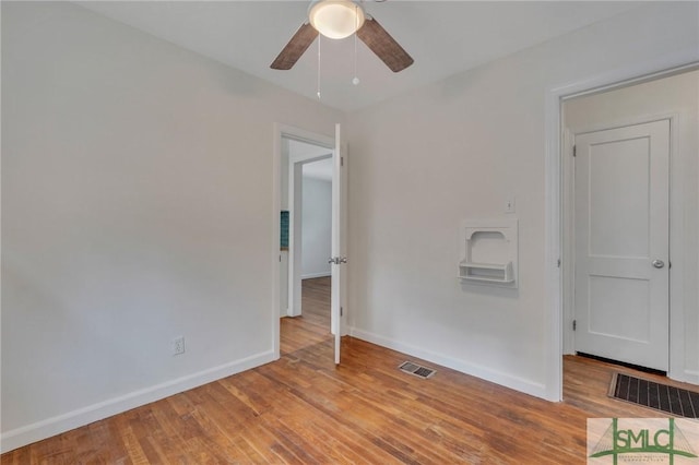 spare room with ceiling fan and light hardwood / wood-style floors