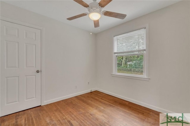 unfurnished room with ceiling fan and hardwood / wood-style flooring