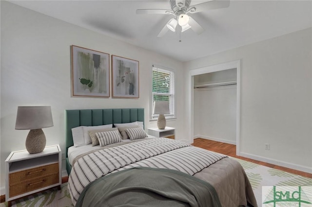 bedroom featuring ceiling fan, light wood-type flooring, and a closet