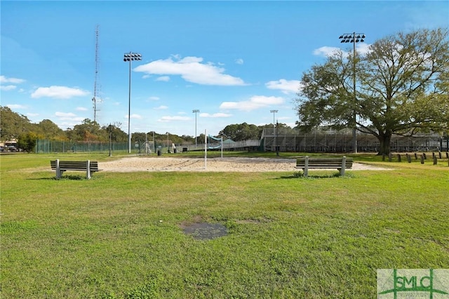 surrounding community with volleyball court and a yard