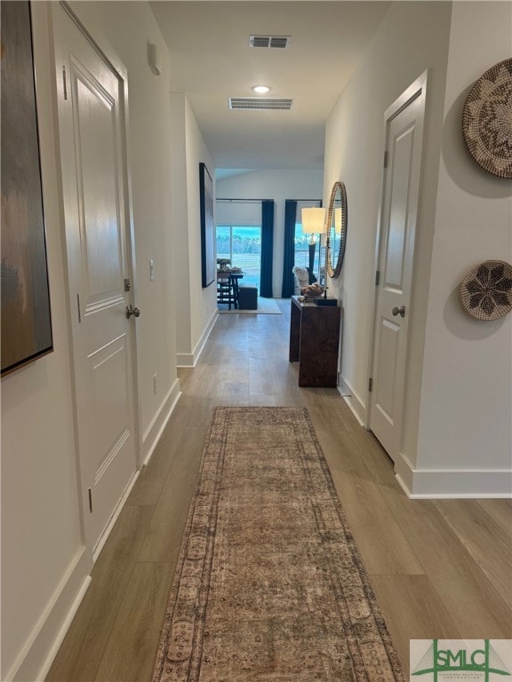 corridor with wood-type flooring