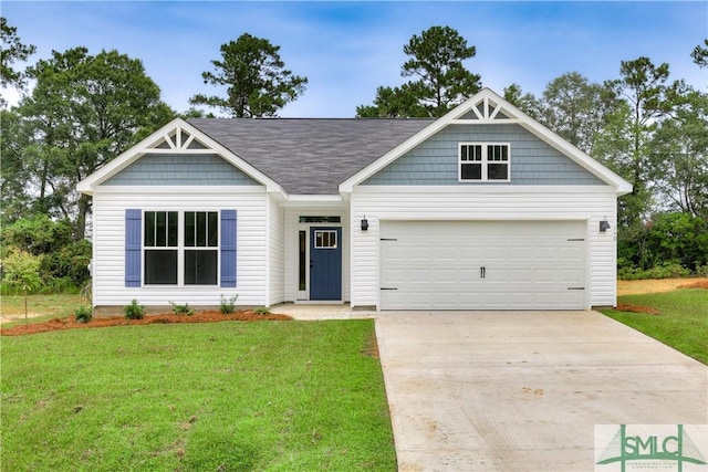 view of front of property with a front lawn and a garage