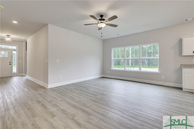 unfurnished living room featuring ceiling fan and light hardwood / wood-style floors