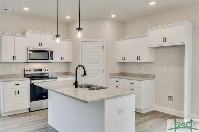 kitchen with sink, an island with sink, decorative light fixtures, white cabinetry, and stainless steel appliances