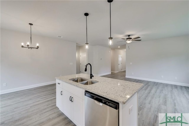 kitchen featuring white cabinetry, sink, stainless steel dishwasher, an island with sink, and decorative light fixtures