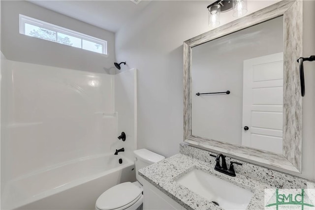 full bathroom featuring toilet, vanity, and washtub / shower combination