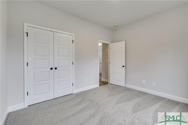 unfurnished bedroom featuring a closet and carpet floors